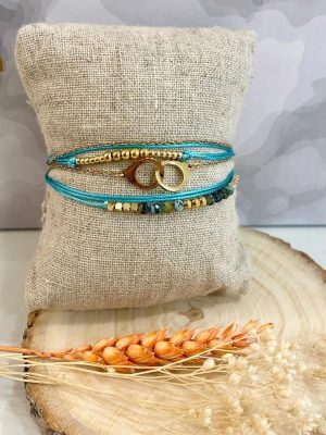 Boutique de bijoux à Toulouse : bracelet multi rangs en acier inoxydable doré avec des menottes, des billes et des fils bleu